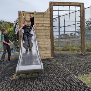 Children Playing Safely On Climbing Frame Slide