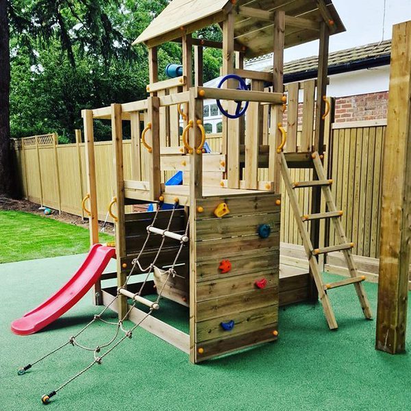 Playground Installed On Green Wet Pour Rubber Surface