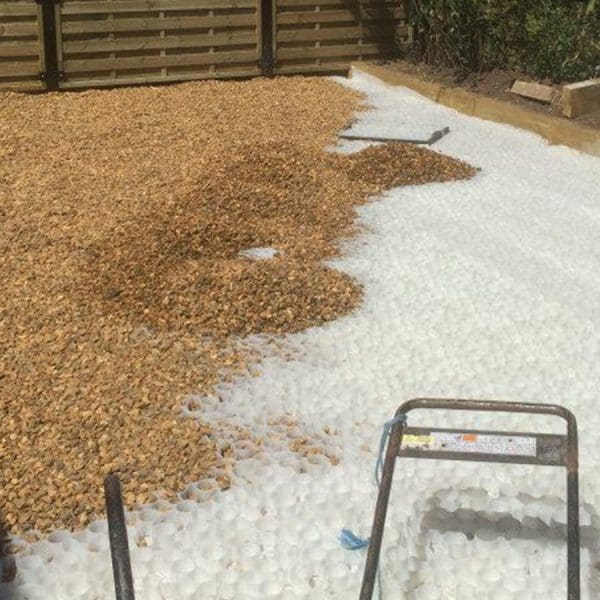 White X-Grid Driveway Being Filled With Gravel